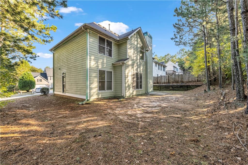 1427 Lost Bridge Road Southwest Marietta, GA 30008 - Photo 5 of 50 a front view of a house with a yard and garage