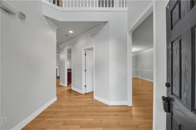 a view of a hallway with wooden floor and staircase