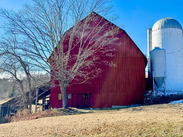 a view of a house with snow next to a road
