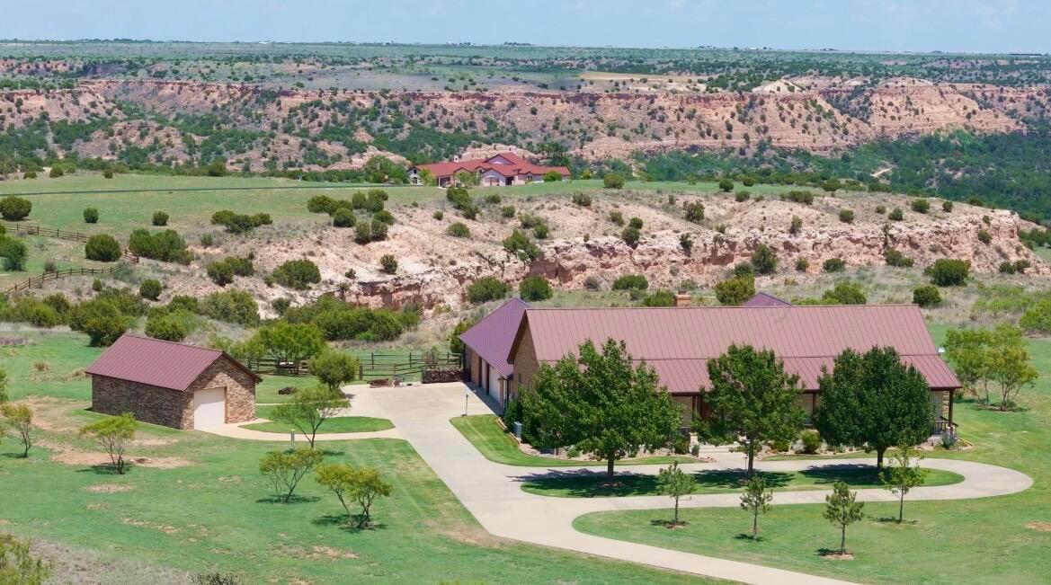 7701 Canyon Bend Road Amarillo, TX 79118 - Photo 72 of 72 an aerial view of a house with a garden and lake view