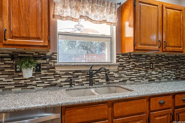 a kitchen with granite countertop a sink and a window