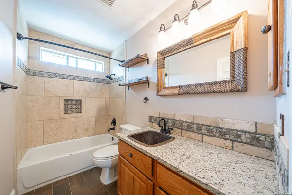 a bathroom with a sink a toilet and bathtub