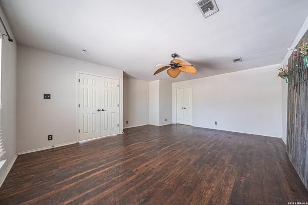 a view of empty room with wooden floor