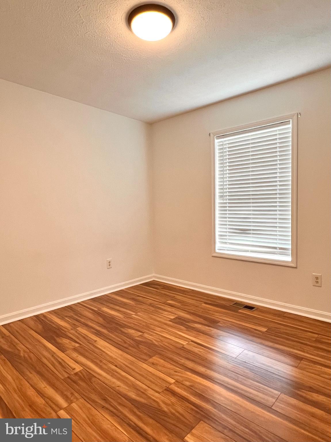 179 Robelei Drive Ranson, WV 25438 - Photo 11 of 17 a view of empty room with wooden floor and fan