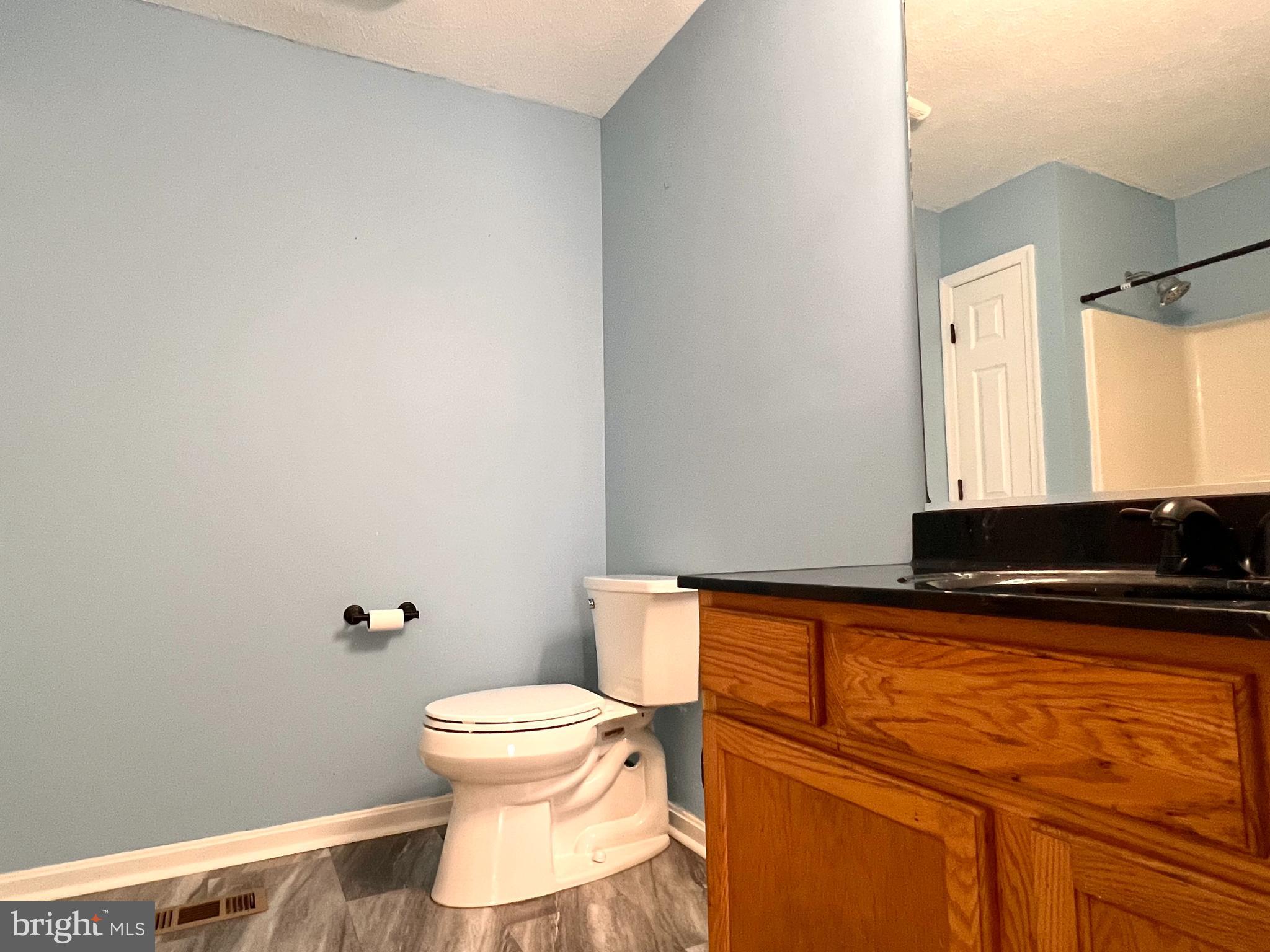 179 Robelei Drive Ranson, WV 25438 - Photo 13 of 17 a bathroom with a toilet a sink and a mirror