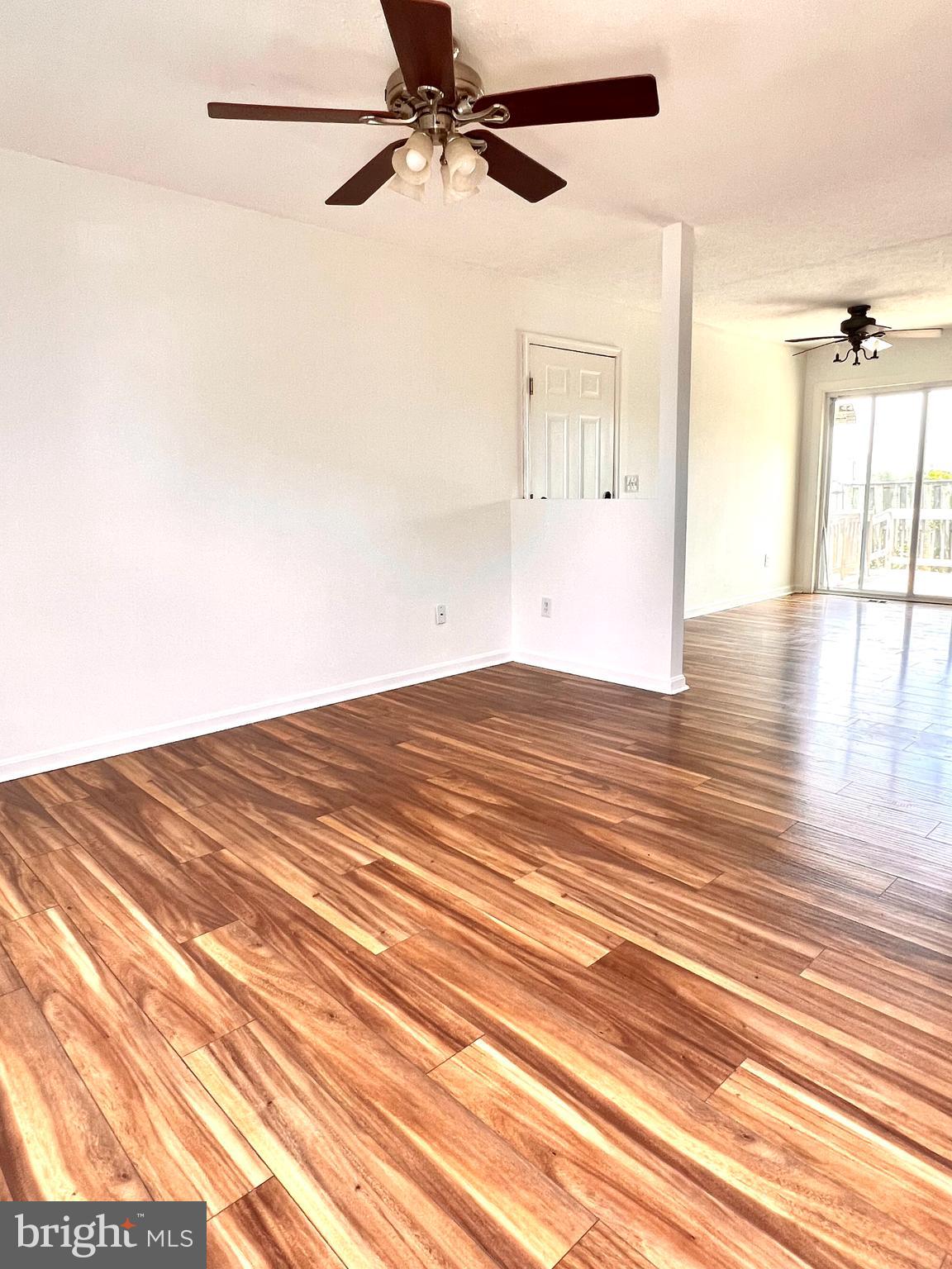 179 Robelei Drive Ranson, WV 25438 - Photo 3 of 17 en empty room with wooden floor and windows