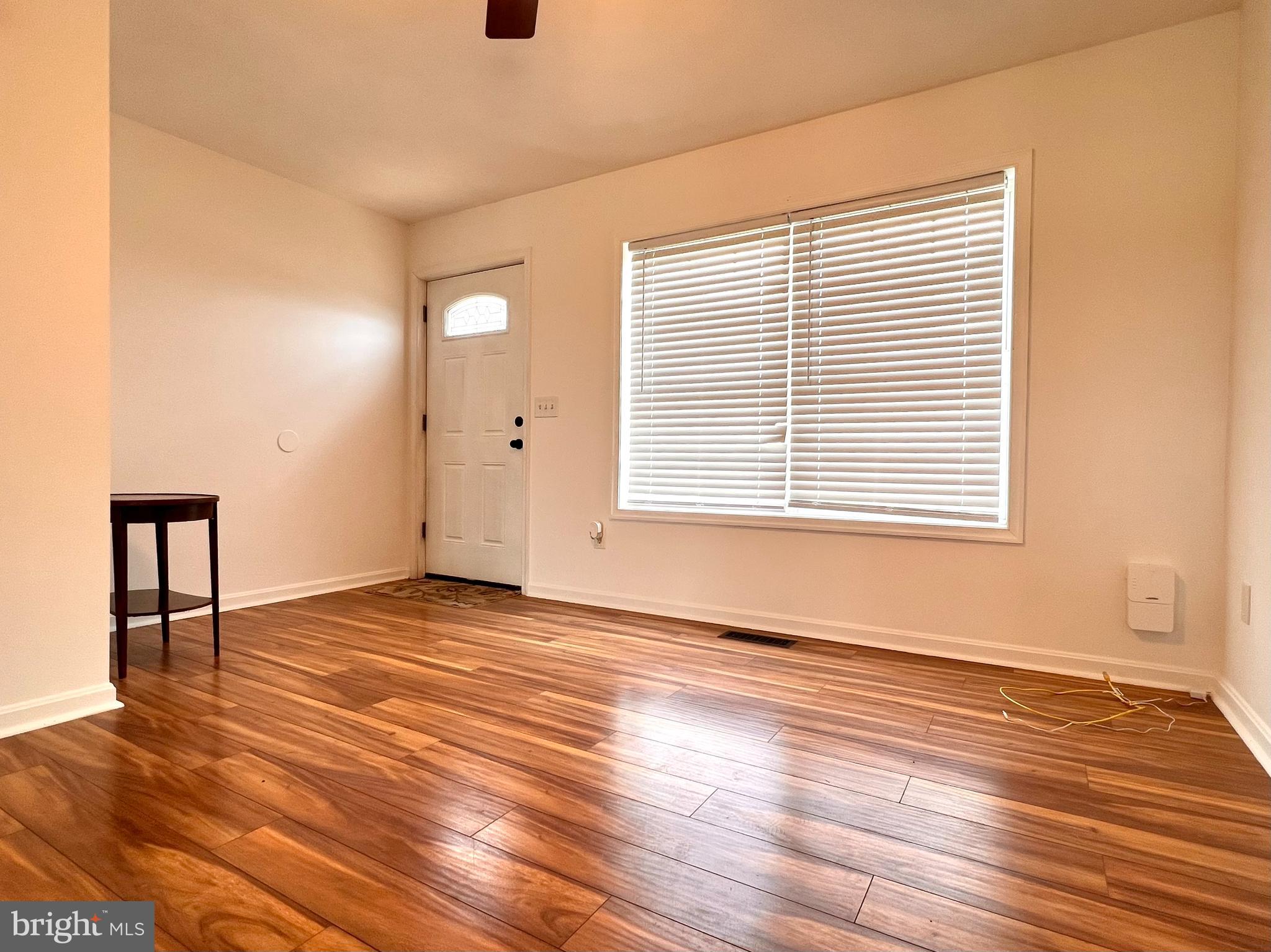 179 Robelei Drive Ranson, WV 25438 - Photo 4 of 17 a view of an empty room with wooden floor and a window
