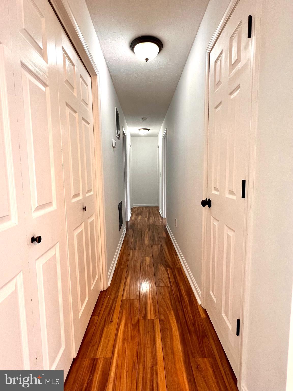 179 Robelei Drive Ranson, WV 25438 - Photo 5 of 17 a view of a hallway with wooden floor and staircase