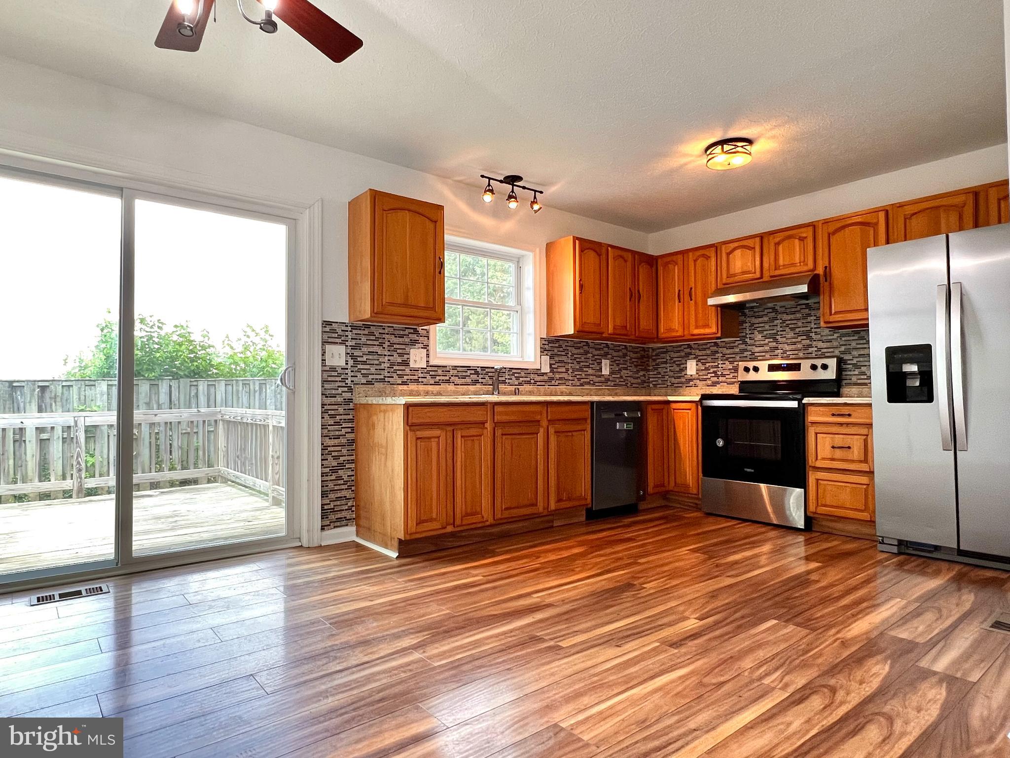 179 Robelei Drive Ranson, WV 25438 - Photo 6 of 17 a kitchen with stainless steel appliances granite countertop a stove top oven and a refrigerator
