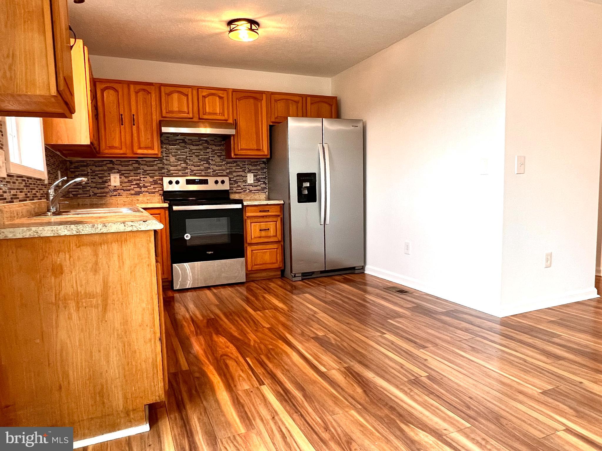 179 Robelei Drive Ranson, WV 25438 - Photo 7 of 17 a kitchen with stainless steel appliances a refrigerator and a stove top oven