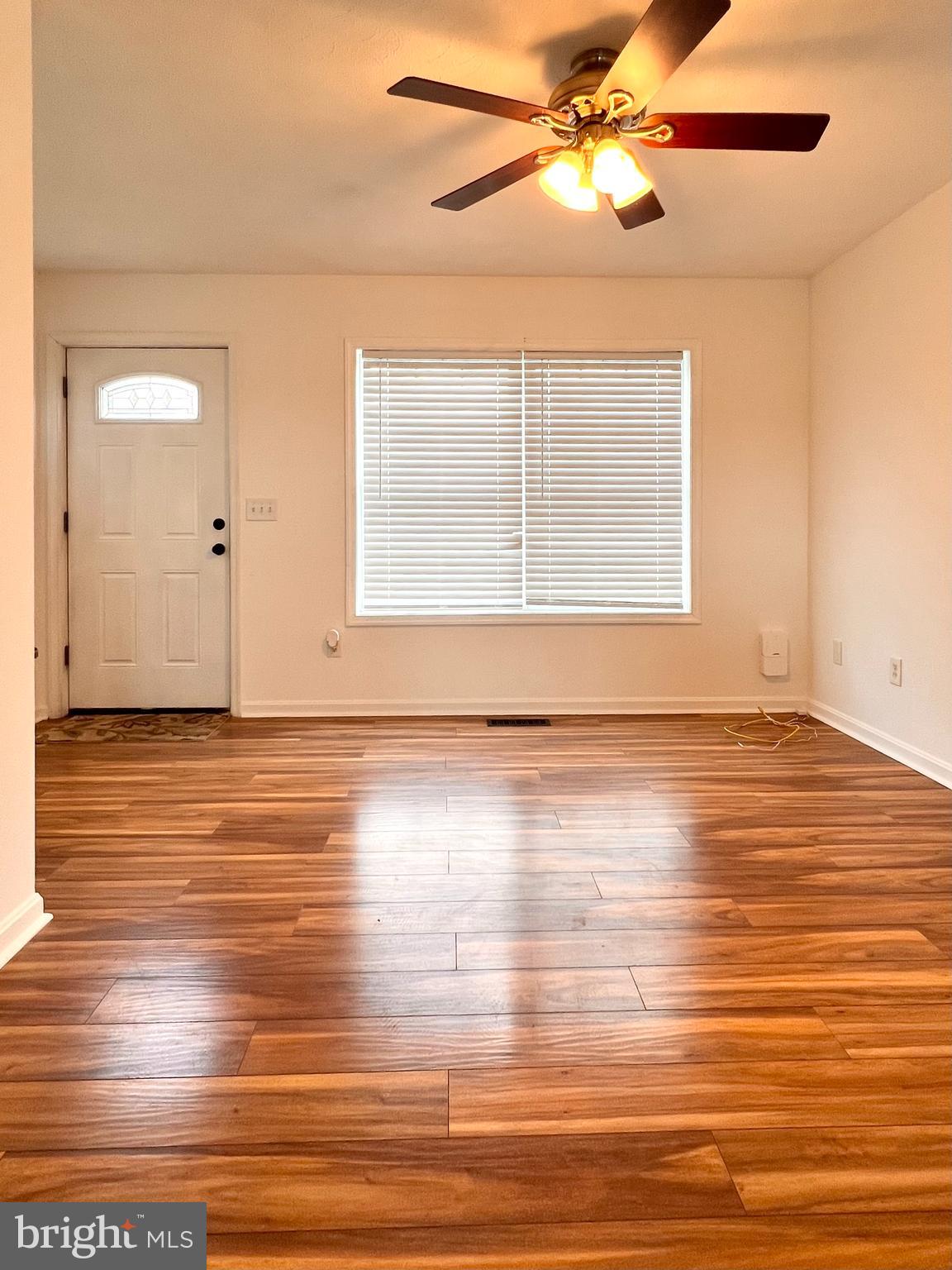 179 Robelei Drive Ranson, WV 25438 - Photo 8 of 17 a view of an empty room with wooden floor and a window