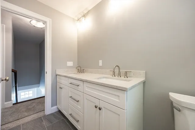 a spacious bathroom with a granite countertop sink and a mirror