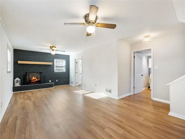 a view of empty room with wooden floor