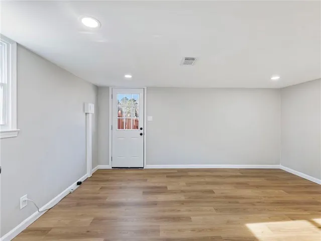 an empty room with wooden floor and closet