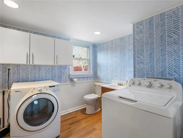 a bathroom with a sink a toilet and a window
