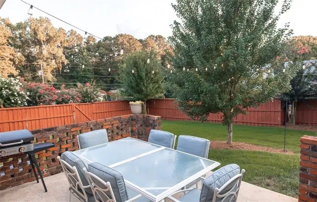 a front view of a house with a yard and trees