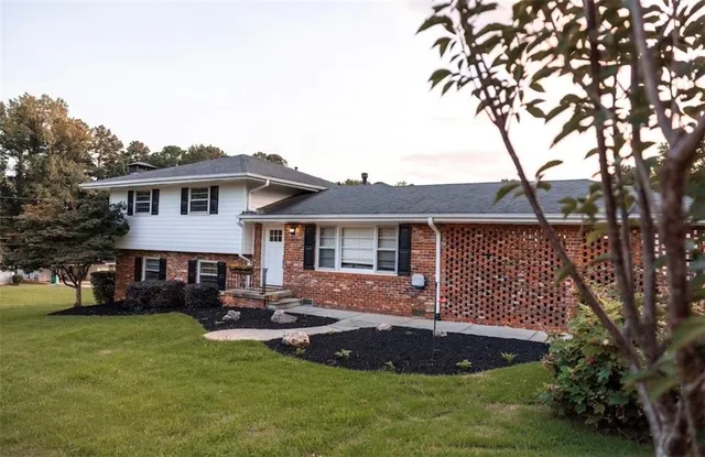 a front view of a house with a garden and deck