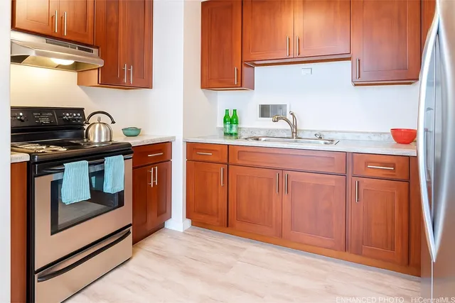 a kitchen with sink cabinets and stainless steel appliances