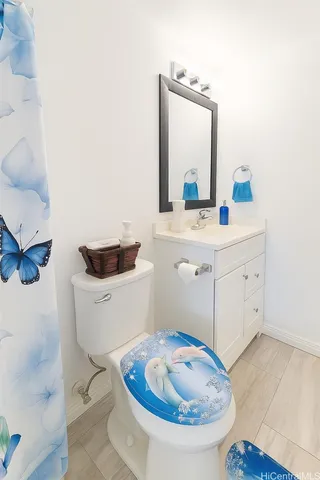 a bathroom with a sink mirror and toilet