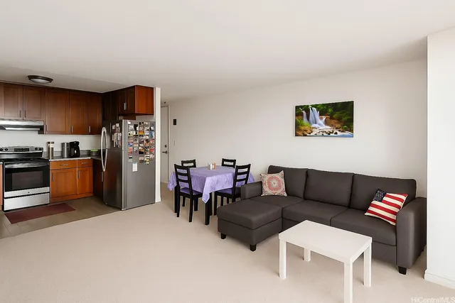 a living room with furniture and a kitchen