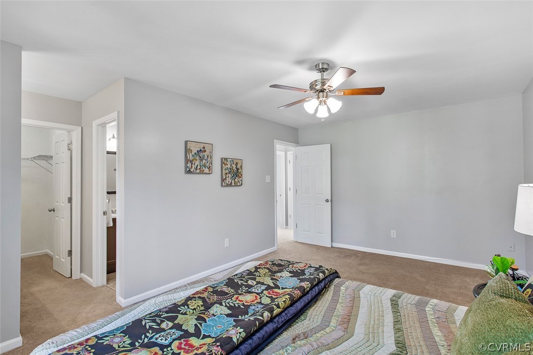 4501 Rabbit Foot Lane North Chesterfield, VA 23236 - Photo 19 of 32 a bedroom with a bed and a chandelier