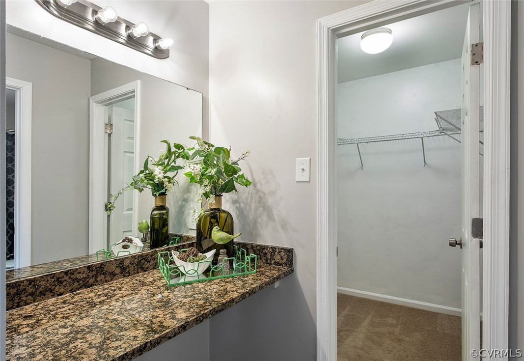 4501 Rabbit Foot Lane North Chesterfield, VA 23236 - Photo 20 of 32 a bathroom with a granite countertop sink a mirror and a shower