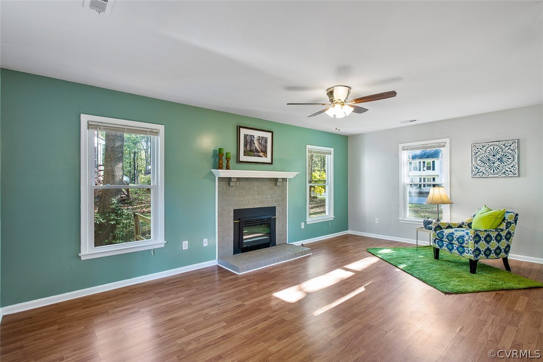 4501 Rabbit Foot Lane North Chesterfield, VA 23236 - Photo 4 of 32 a view of a livingroom with a fireplace a chandelier and wooden floor