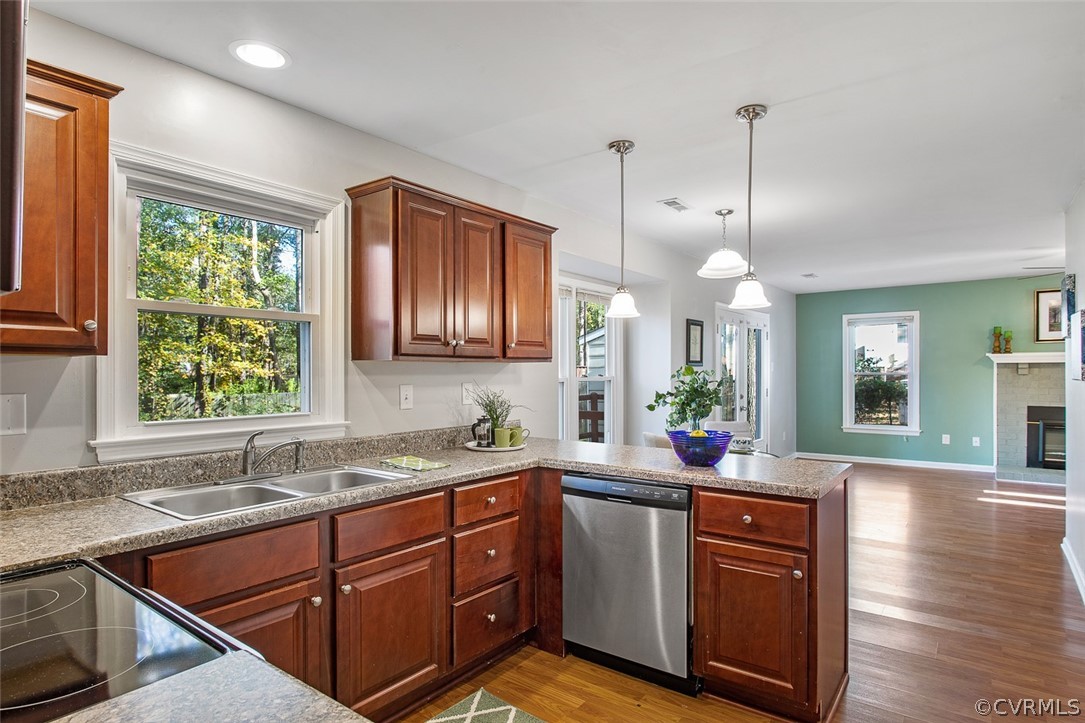 4501 Rabbit Foot Lane North Chesterfield, VA 23236 - Photo 7 of 32 a kitchen with stainless steel appliances granite countertop wooden cabinets a sink a window and wooden floor