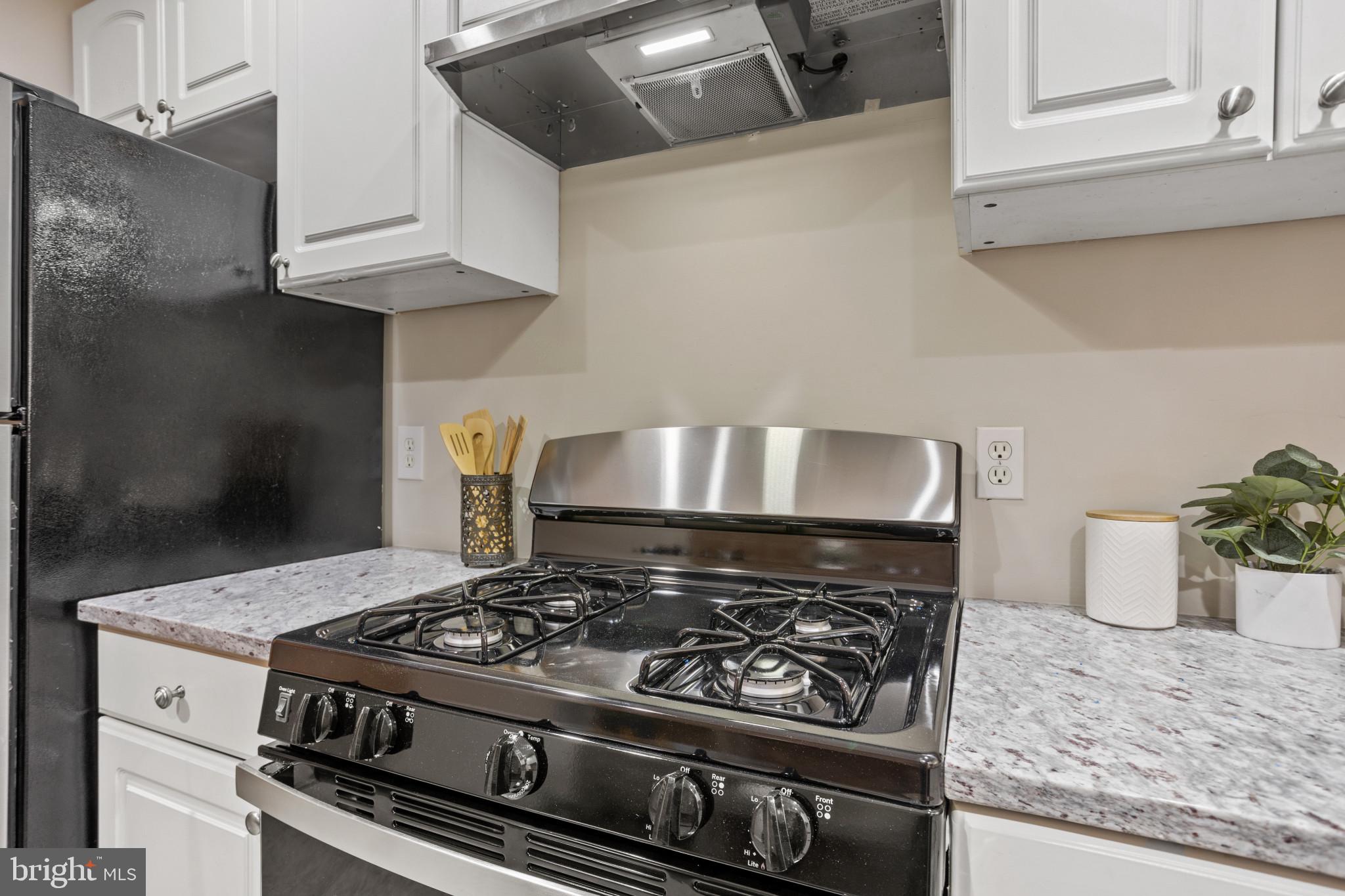 1432 Andre Street Baltimore, MD 21230 - Photo 10 of 25 a stove top oven sitting inside of a kitchen