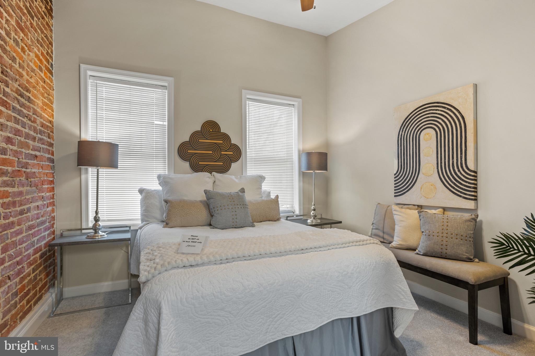 1432 Andre Street Baltimore, MD 21230 - Photo 16 of 25 a bedroom with a bed and a lamp on table