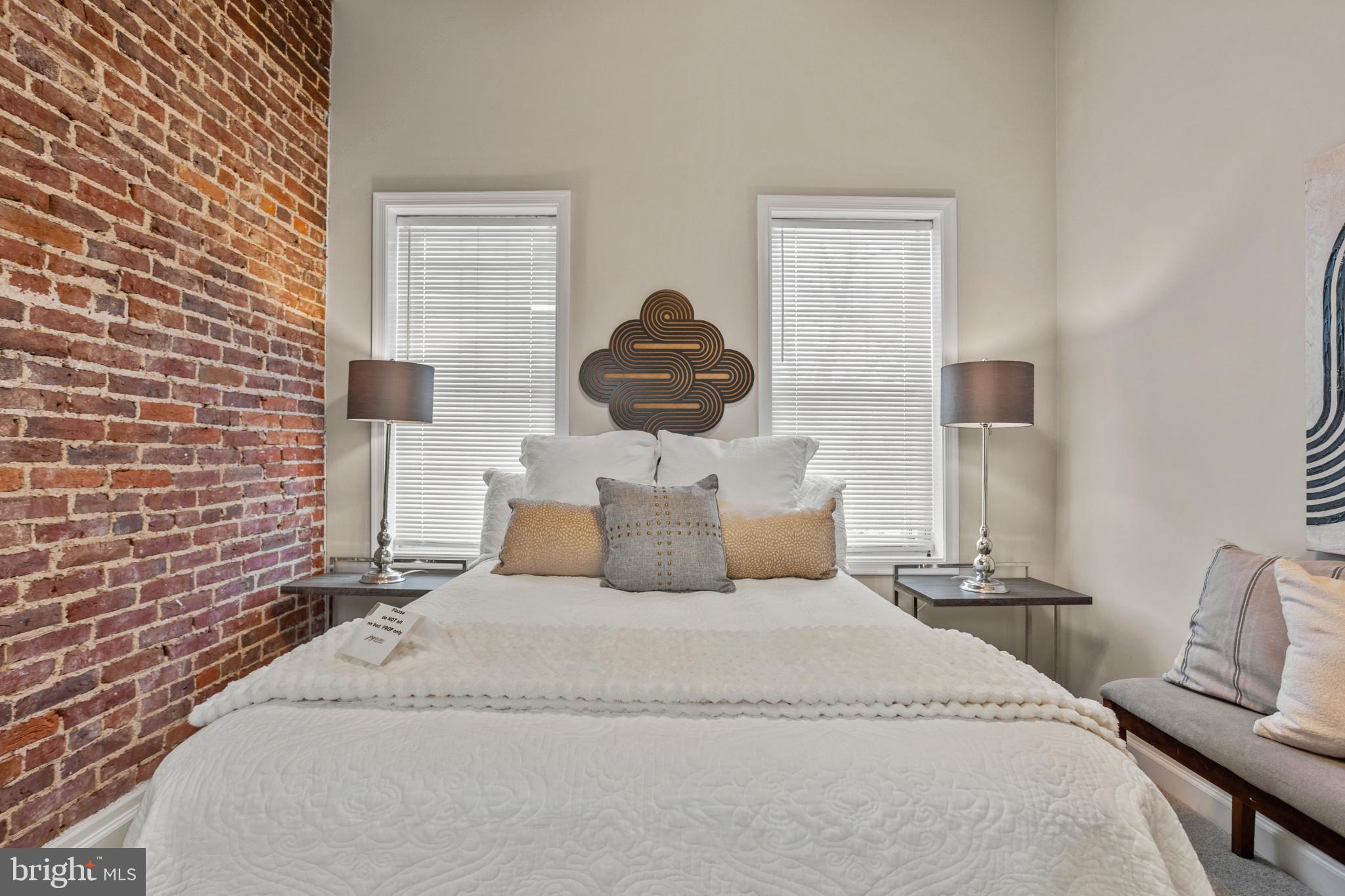 1432 Andre Street Baltimore, MD 21230 - Photo 17 of 25 a bedroom with a bed and a lamp on dresser