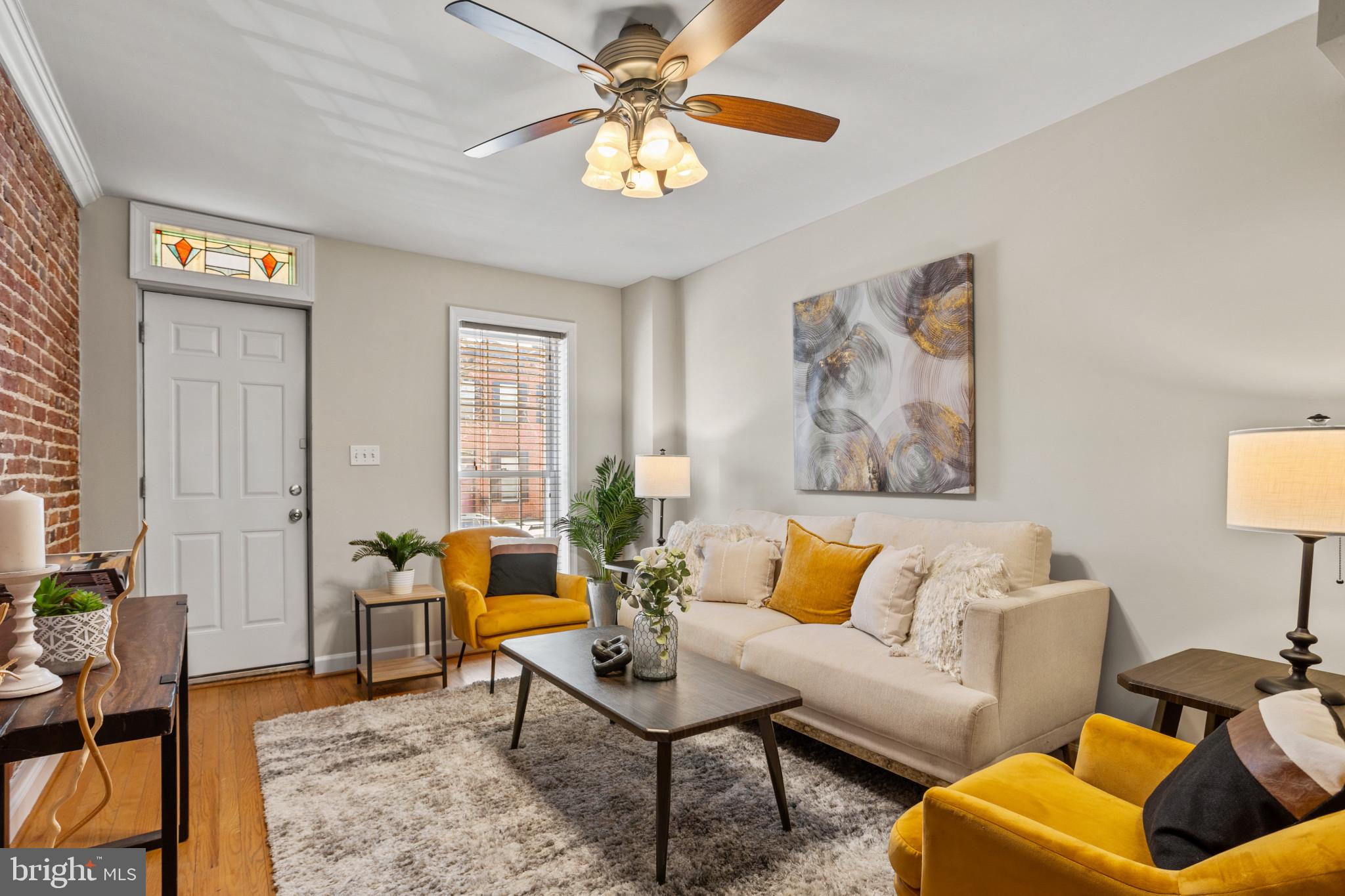 1432 Andre Street Baltimore, MD 21230 - Photo 3 of 25 a living room with furniture and a potted plant
