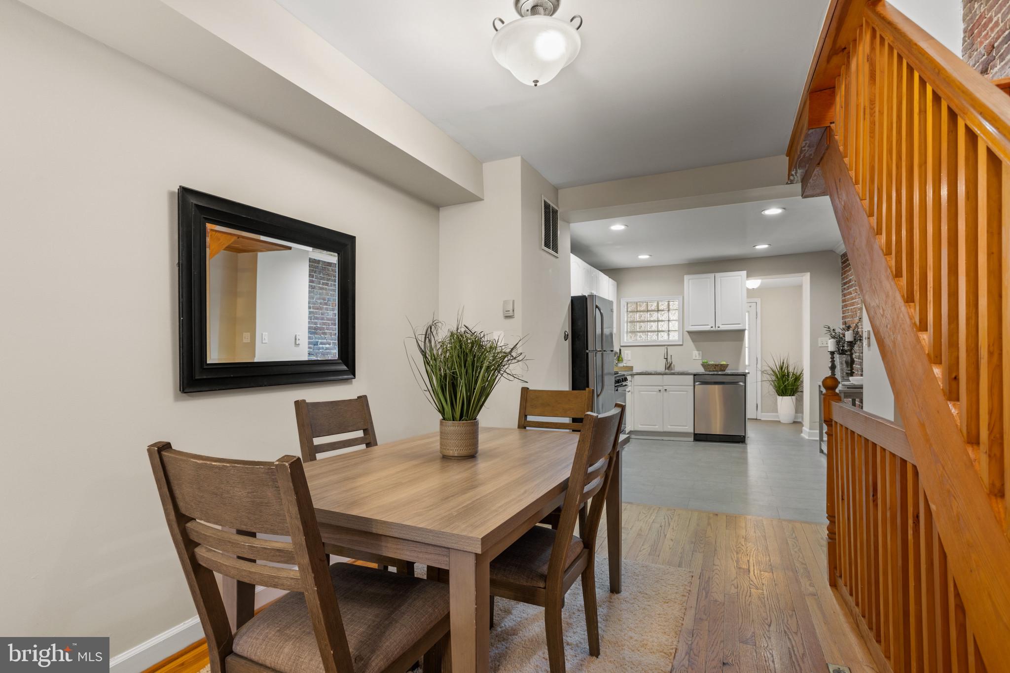1432 Andre Street Baltimore, MD 21230 - Photo 4 of 25 a view of a dining room with furniture and a potted plant