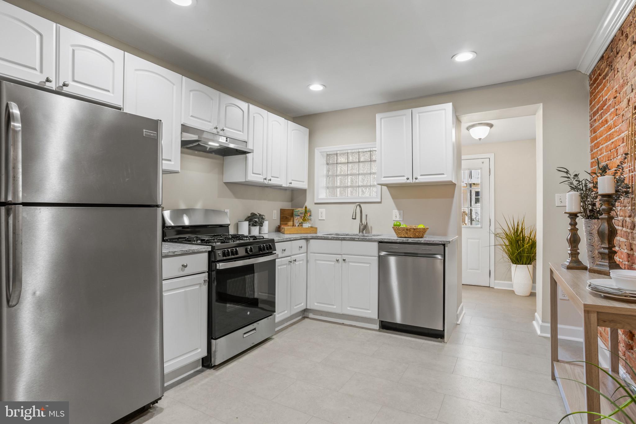 1432 Andre Street Baltimore, MD 21230 - Photo 6 of 25 a kitchen with stainless steel appliances a refrigerator sink and stove