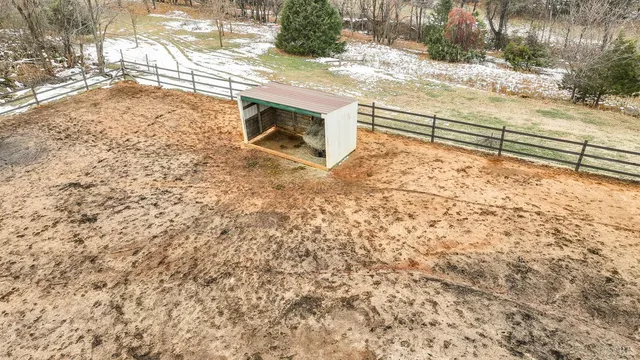 a view of a dining room and livingroom with furniture wooden floor a chandelier