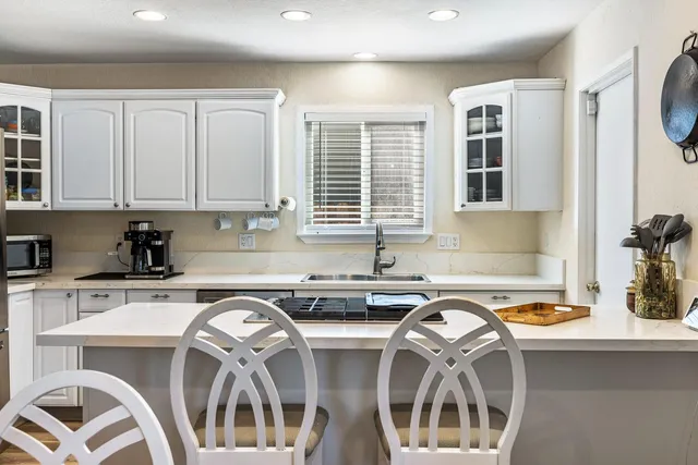 a kitchen that has a stove and a table in it
