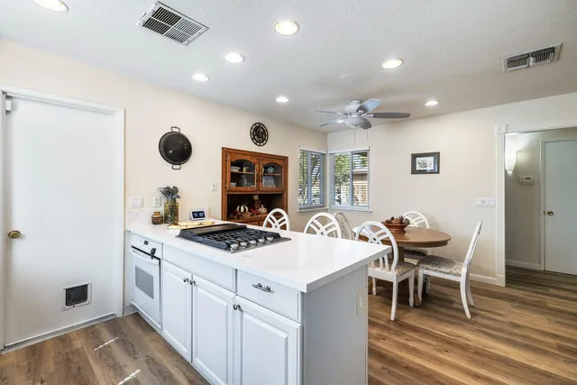 a kitchen with appliances cabinets a sink and a window