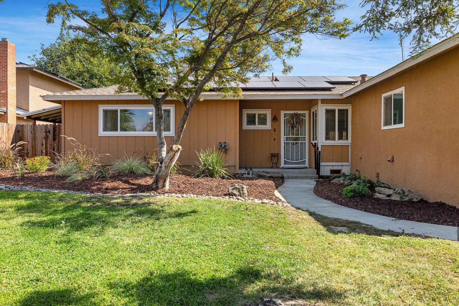 2877 Caesar Avenue Clovis, CA 93612 - Photo 2 of 32 a view of a house with backyard sitting area and garden
