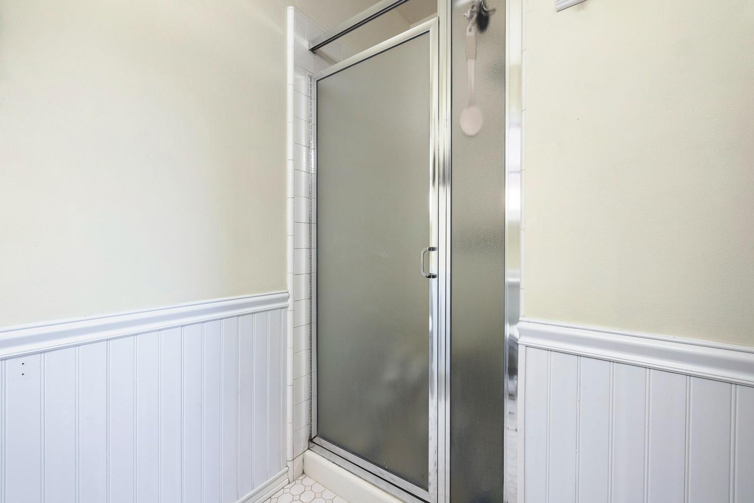 2877 Caesar Avenue Clovis, CA 93612 - Photo 26 of 32 a bathroom with a glass shower door