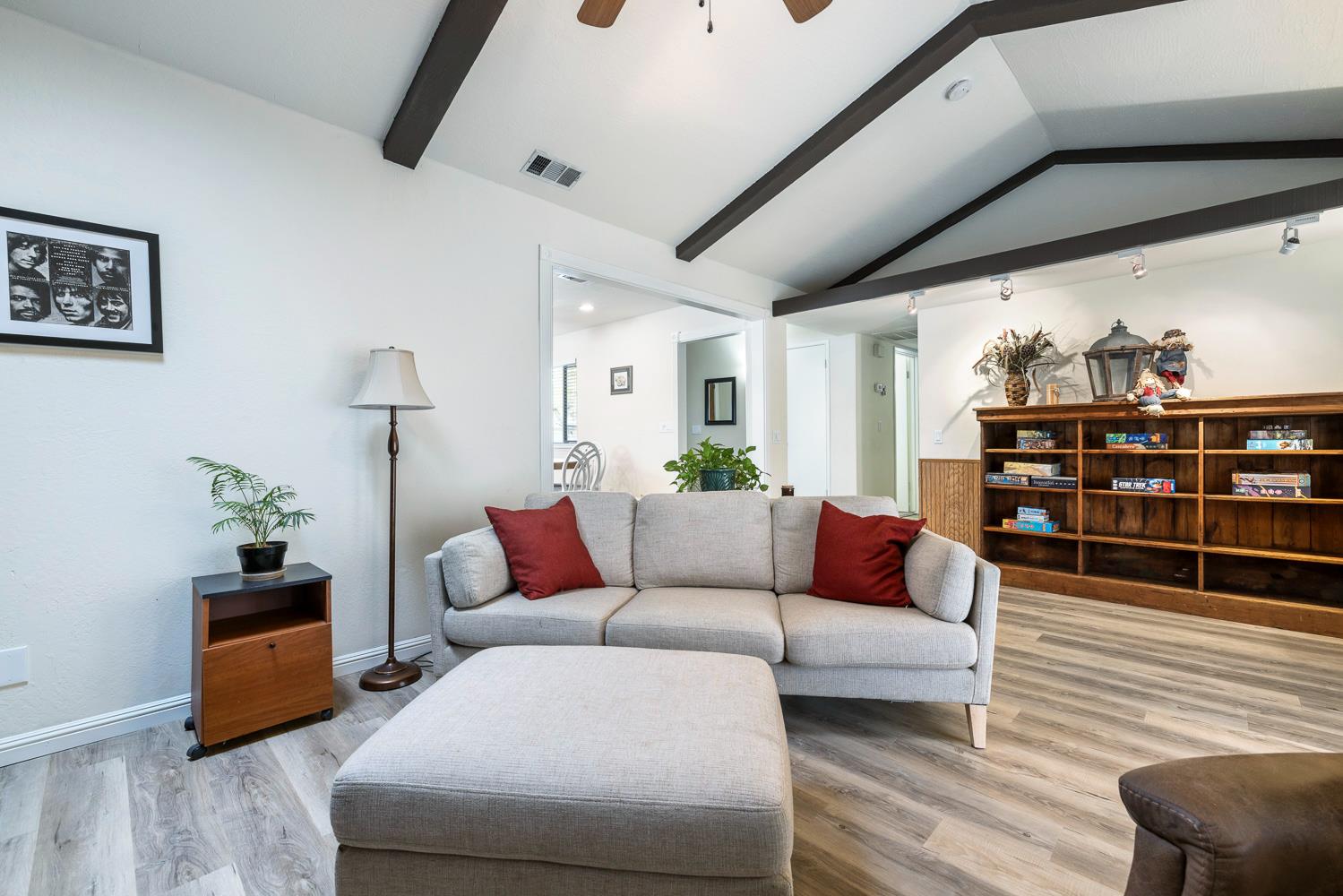 2877 Caesar Avenue Clovis, CA 93612 - Photo 8 of 32 a living room with furniture a rug and a bookshelf