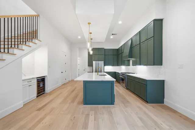 a kitchen with stainless steel appliances a stove and cabinets