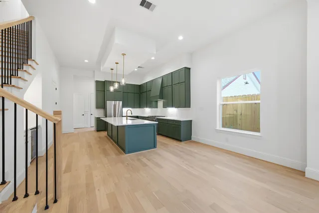 a large kitchen with a large window and stainless steel appliances