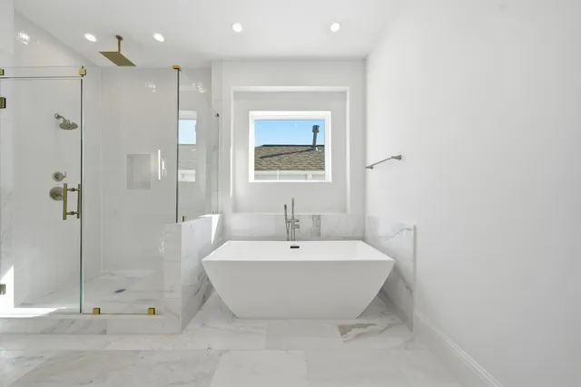 a spacious bathroom with a bathtub and shower