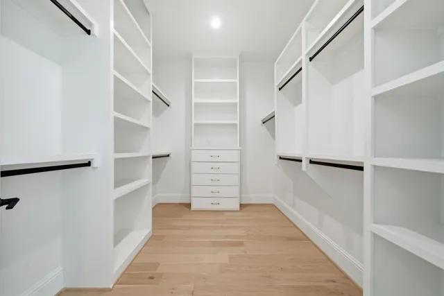 a view of walk in closet with empty racks