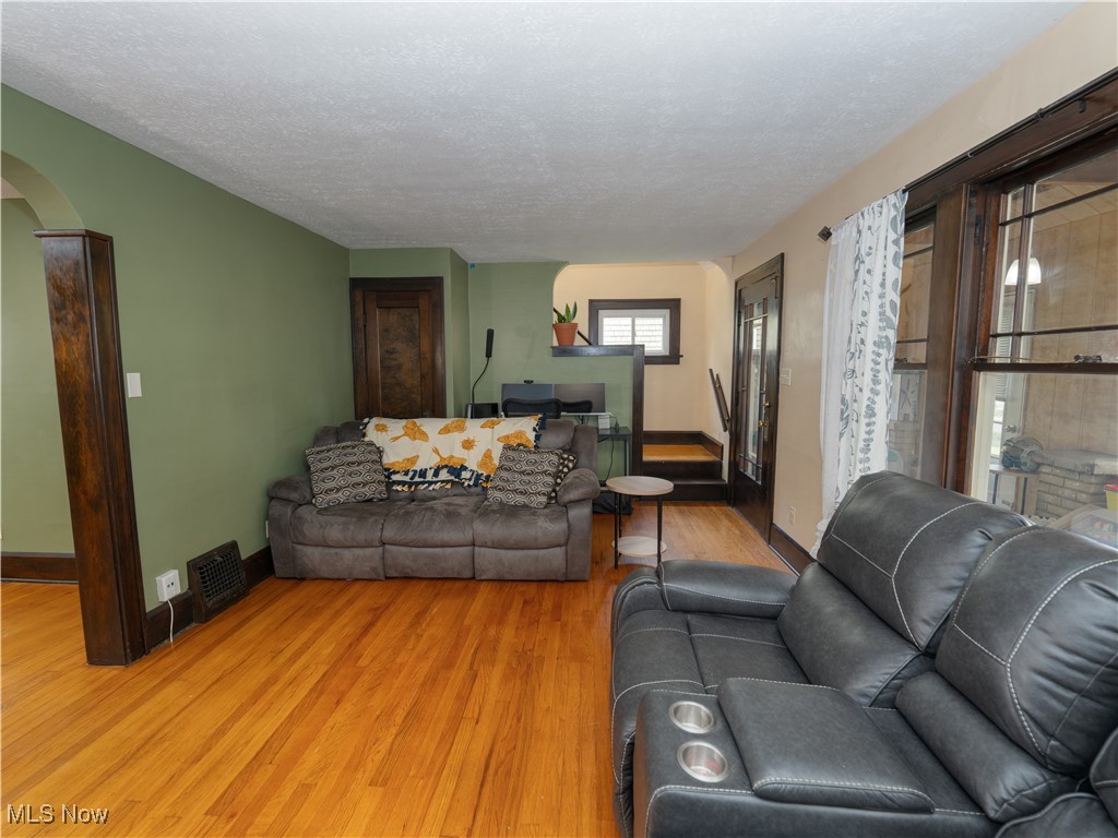 6021 Snow Road Parma, OH 44129 - Photo 3 of 28 Living room with arched walkways and wood finished floors
