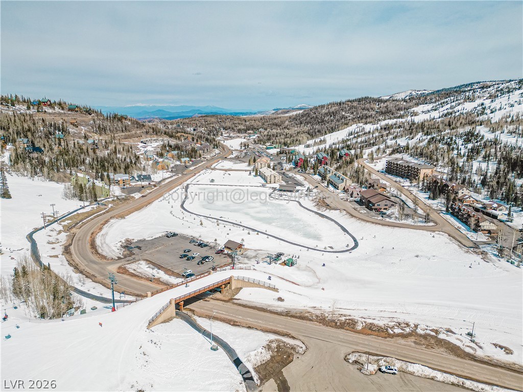407 South Vasels Road, Unit 49 Brian Head, UT 84719 - Photo 37 of 40 Snowy aerial view with a mountain view