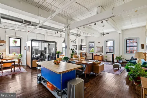 a living room with lots of furniture and wooden floor