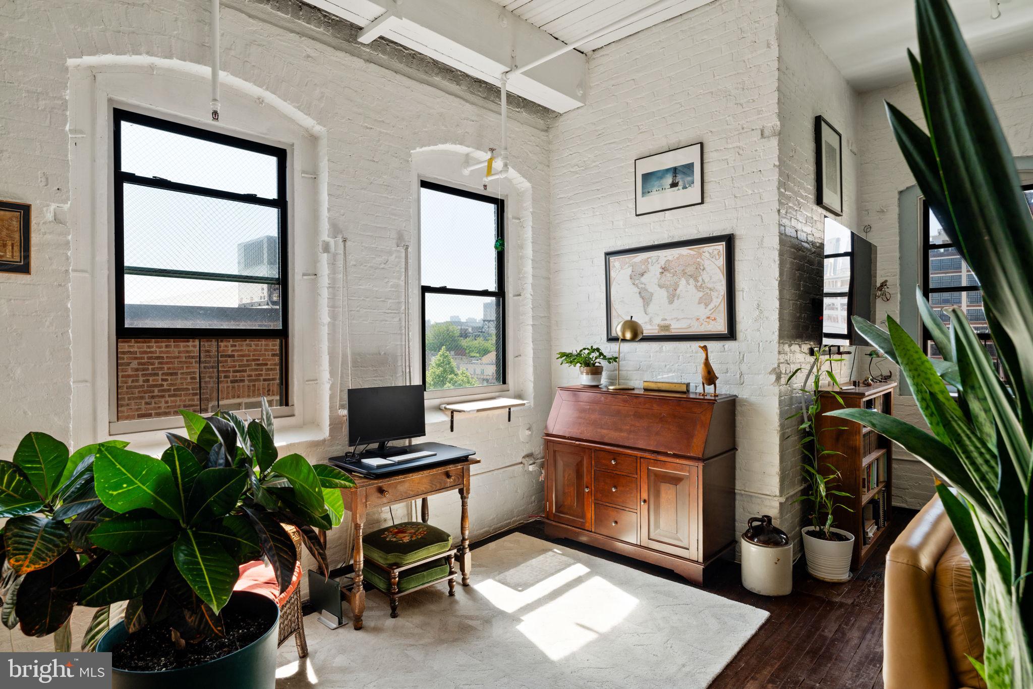 429 North 13th Street, Unit 5G Philadelphia, PA 19123 - Photo 13 of 39 a living room with furniture a potted plant and a window