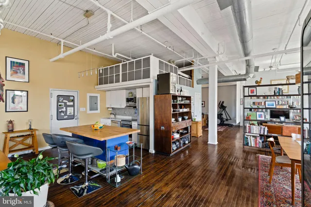 a view of a dining room with lots of furniture and wooden floor