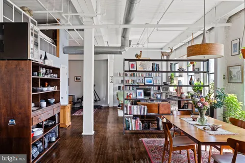 a view of a workspace with furniture window and wooden floor